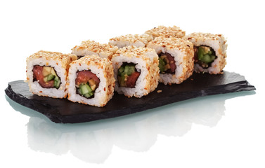 Sushi rolls arranged on special black plate isolated on white