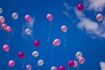 Red ballons with the messages in the blue sky