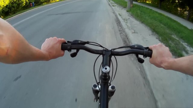POV Road cyclist on asphalt road at sunset ridind through the city khmelnytskyi ukraine 2