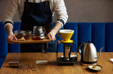 Barista making coffee, bartender or coffee maker preparing coffee drink
