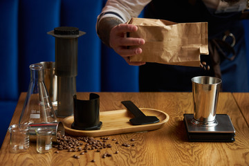 Barista making coffee, bartender or coffee maker preparing coffee drink