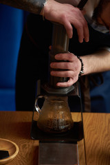 Barista making coffee, bartender or coffee maker preparing coffee drink