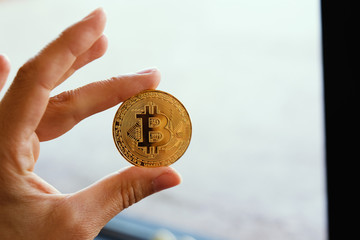 Bitcoin digital currency coin in hand for business.