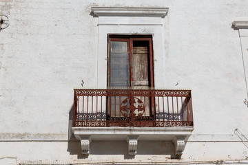 Fototapeta na wymiar Italy, SE Italy, Ostuni. Balcony and old wooden door.