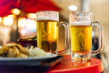 Two glasses with beer on the table, Tokyo, Japan. Close-up.