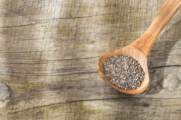 Chia seeds on the wooden table - Salvia hispanica