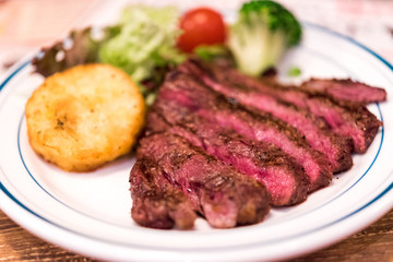 Fried beef with potatoes, decorated with vegetables, Tokyo, Japan. Close-up.