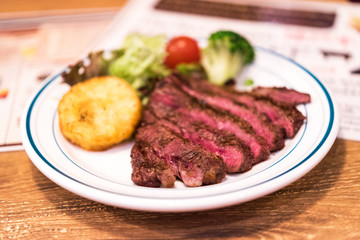 Fried beef with potatoes, decorated with vegetables, Tokyo, Japan. Close-up.