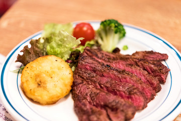 Fried beef with potatoes, decorated with vegetables, Tokyo, Japan. Close-up.