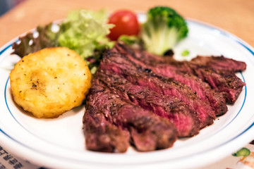 Fried beef with potatoes, decorated with vegetables, Tokyo, Japan. Close-up.