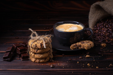 Coffee mood.dark background. coffee, cookies chocolate and crumbled coffee beans