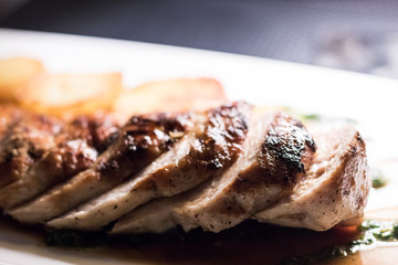 Grilled chicken fillet and sliced on a plate