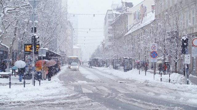 White city street in snow blizzard in slow motion 4K