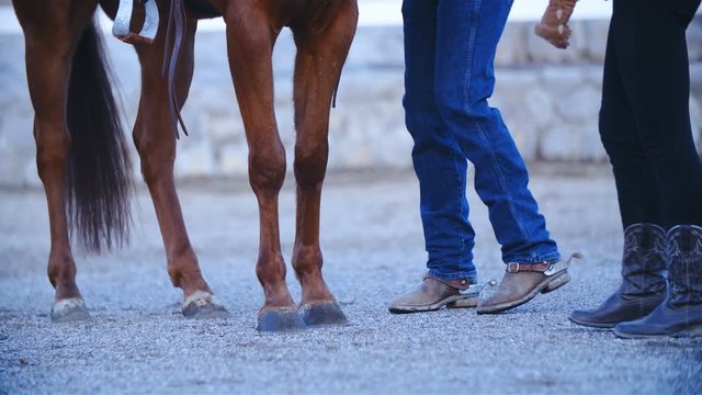 Two cowboys legs near the horse 4K