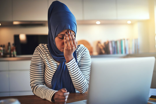 Young Arabic female entrepreneur looking stressed while working