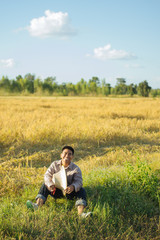 Fototapeta na wymiar Brown Skin Farmer And His Rice Field