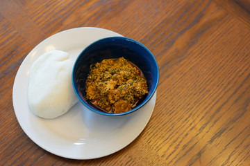 Nigerian Pounded Yam Served with Egusi Soup 