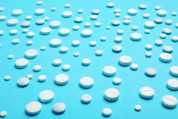 White pills on color background