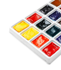 Plastic palette with colorful paints on white background