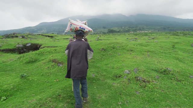 African people carrying sacks