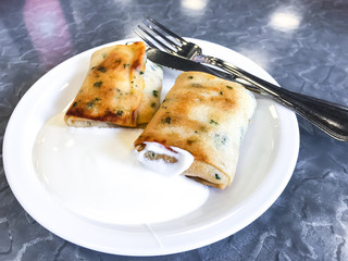Stuffed pancakes with sour cream