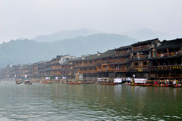 HUNAN, CHINA - JUNE 16, 2014 : Old houses in Fenghuang county in Hunan, China. The ancient town of...
