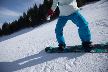  woman snowboarding in winter mountains