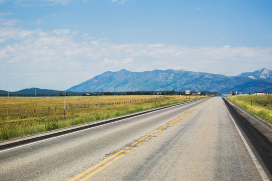Highway in remote Montana landscape. Summer day setting.