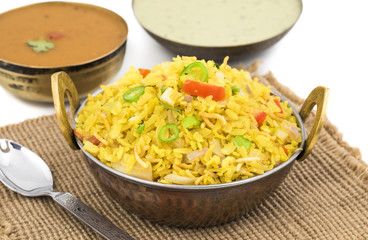 Indian Breakfast Dish Poha Also Know as Pohe or Aalu poha made up of Beaten Rice or Flattened Rice. The rice flakes are lightly fried in oil with mustard, chilly, onion, curry leaves and turmeric