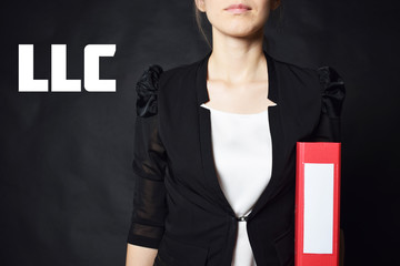 A businessman holds a folder with the inscription:LLC