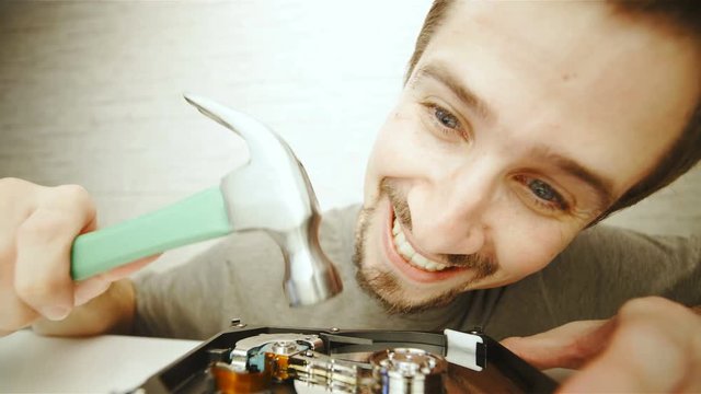 Destroying hard disk drive with a hammer in slow motion 4K