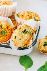Savory potato spinach and feta muffins in a bowl. White stone background.