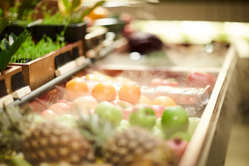 Fresh oranges, apples and other fruits in boxes of contemporary farming supermarket