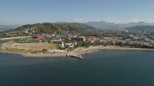 Coastline with beach and lighthouse, mountains. Aerial view: Coast sea with hotels, resorts, Subic Bay, Philippines, Luzon