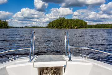 View to lake landscape from motor boat with details of boat