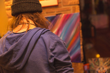 Artist Painting a Texture or Backdrop on Canvas in Public