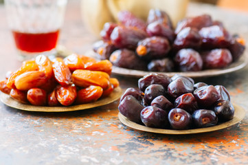 Set of various of dried dates or kurma in a vintage plates.