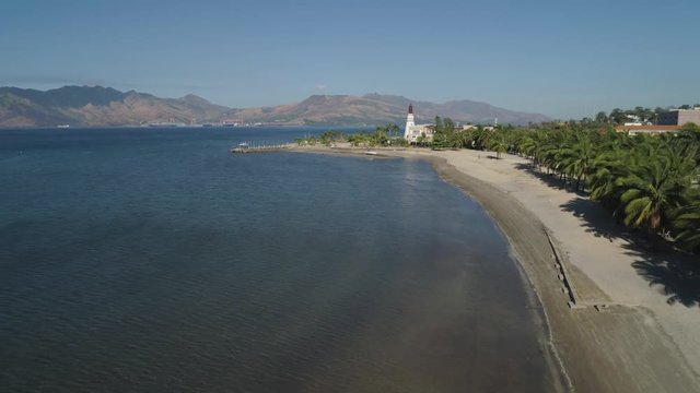 Coastline with beach and lighthouse, mountains. Aerial view: Coast sea with hotels, resorts, Subic Bay, Philippines, Luzon