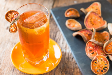 Bael juice ice tea on wooden table , healthy drink