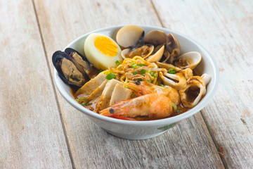seafood curry noodle with wood background