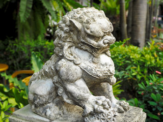 Fototapeta na wymiar Traditional Guardian Lion Sandstone Statue in the City Park