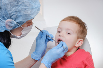 Dentist medical examination of child patient teeth using a mirror of instrument Caries, tooth...