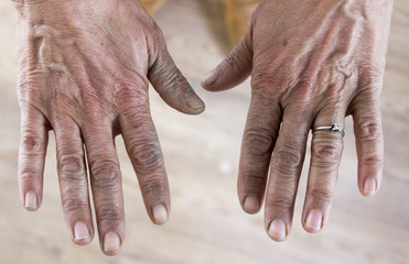 Tired hands of an old woman