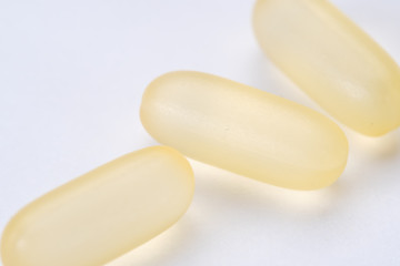 yellow white pills capsule isolated on white background