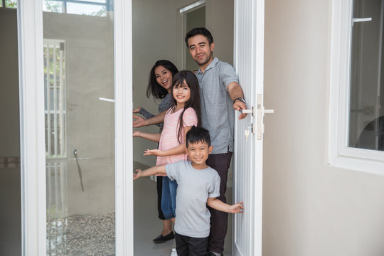 Happy Family With Kids Open Their House Door 