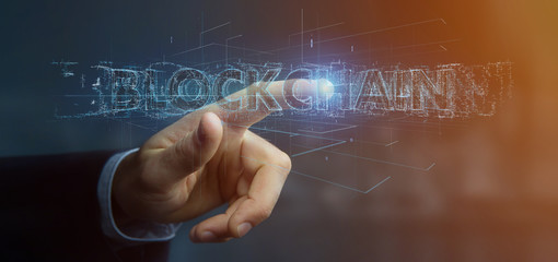 Businessman holding a Blockchain title isolated on a background