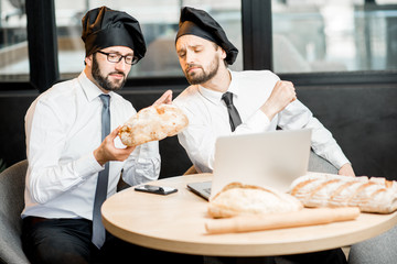 Bakers working with bread in the office