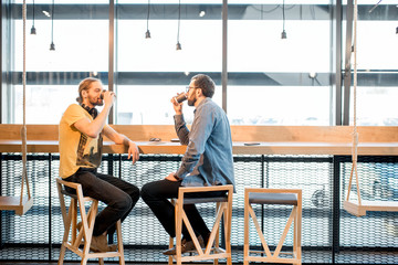 Two friends during the coffee break in the cafe