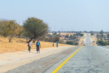 Poor people walking on the roadside in the rural Caprivi Strip, the most populated region in...