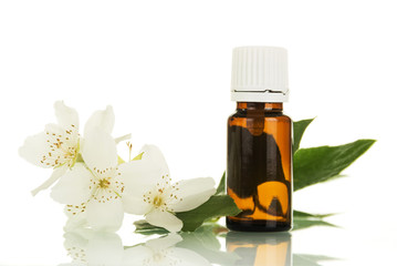 Bottle of aromatic liquid for vaping electronic cigarette and Jasmine flower isolated on white